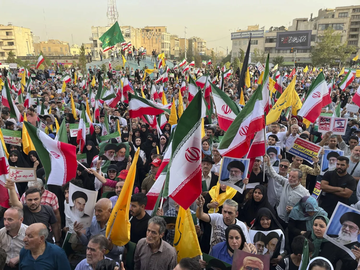 إيرانيون يحملون أعلاماً في طهران أمس (أ.ب)