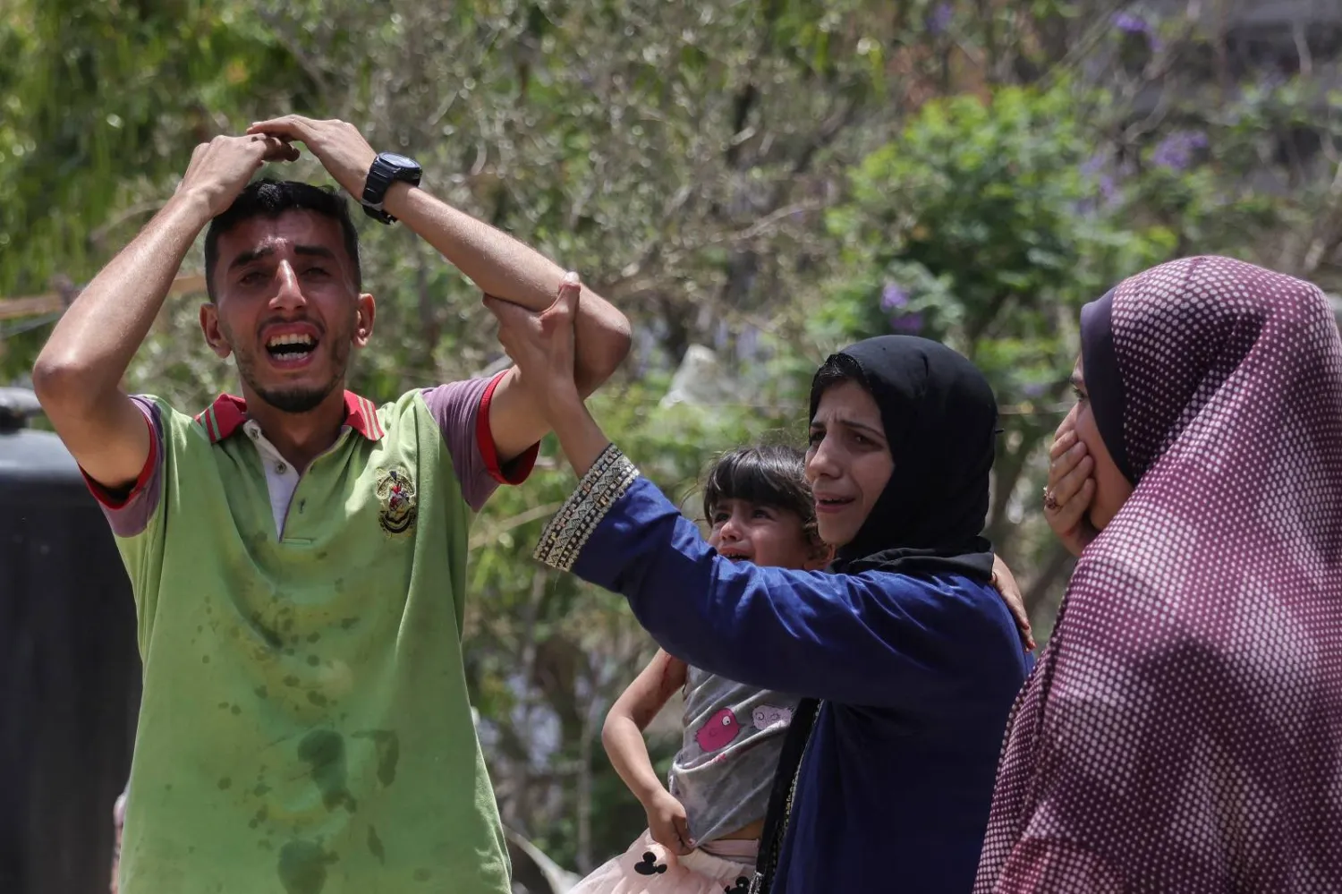 شاب فلسطيني ينعى أحد أقاربه الذي قتل في غارة إسرائيلية غرب جباليا خلال وقت سابق (أ.ف.ب)