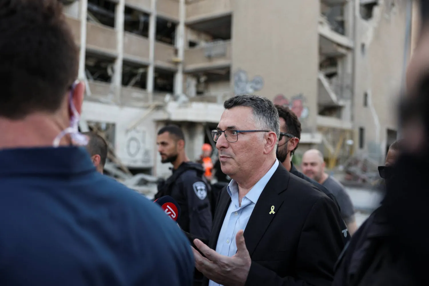 وزير الخارجية الإسرائيلي جدعون ساعر يتحدث للصحافيين عقب تفقده موقع سقوط صاروخ إيراني في حيفا (رويترز) 