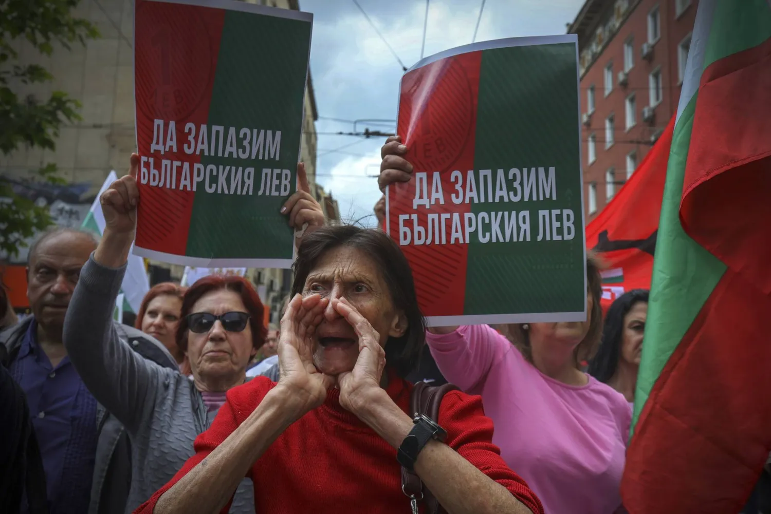 A protester shouts anti-euro slogans in front of signs reading 'Preserve Bulgarian Lev!' during an anti-Euro protest in Sofia, Bulgaria, Saturday 31, May 2025. (AP Photo/Valentina Petrova)