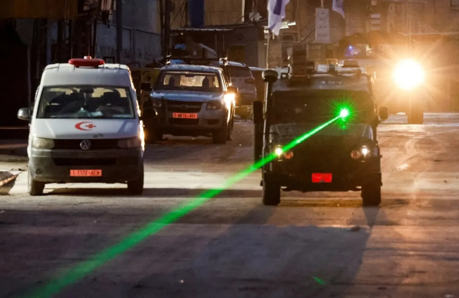 An Israeli military vehicle uses a laser, on the day of an Israeli raid in Jenin, in the Israeli-occupied West Bank, January 21, 2025. (Reuters)
