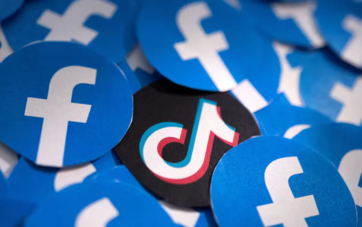 Printed Facebook and TikTok logos are seen in this illustration taken February 15, 2022. REUTERS/Dado Ruvic/Illustration/File Photo 