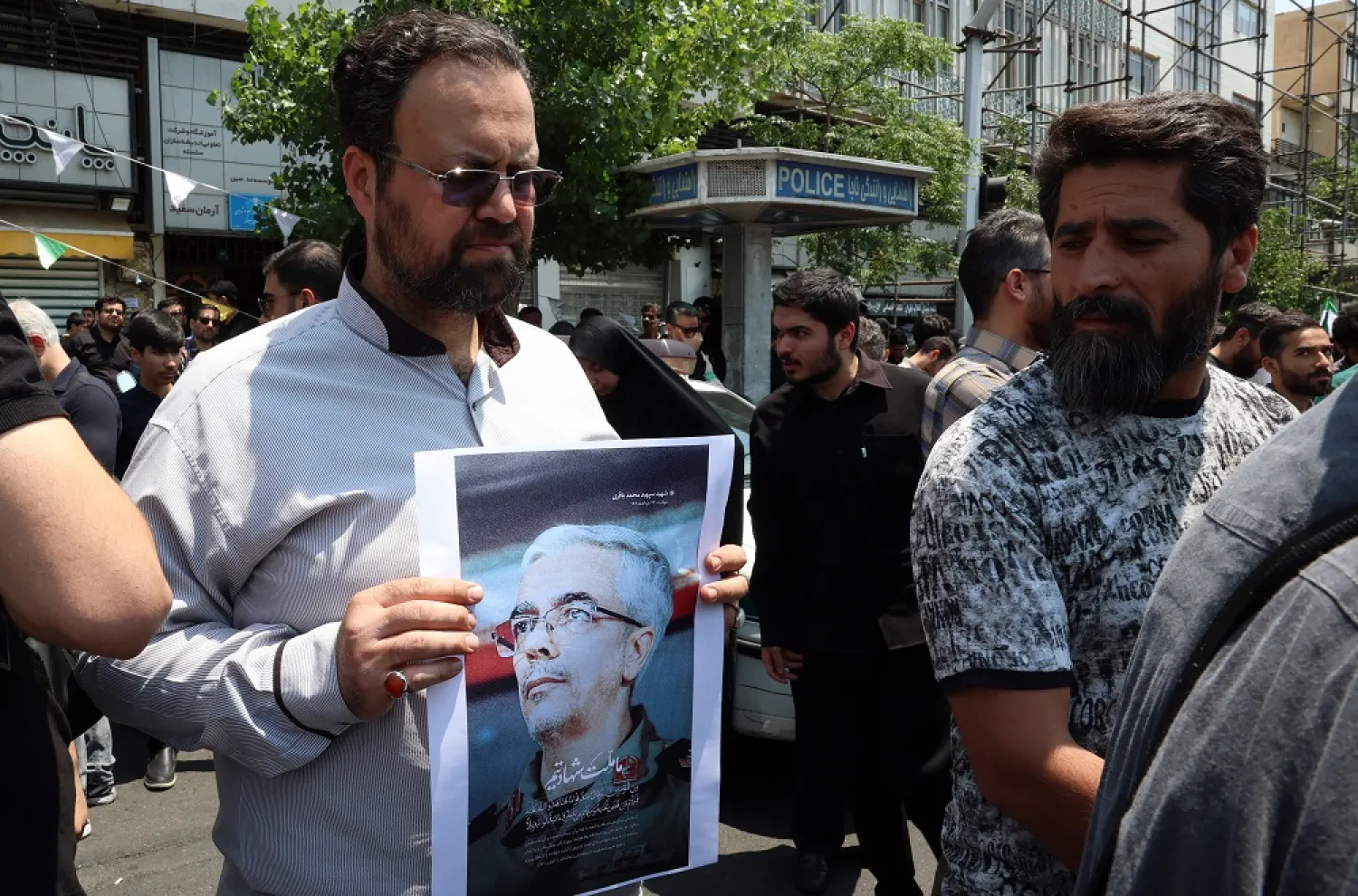 An Iranian holds a portrait of Iranian Armed Forces Chief of Staff General Mohammad Bagheri who was killed in an Israel airstrike, during a protest in Tehran, Iran, 13 June 2025. (EPA) 