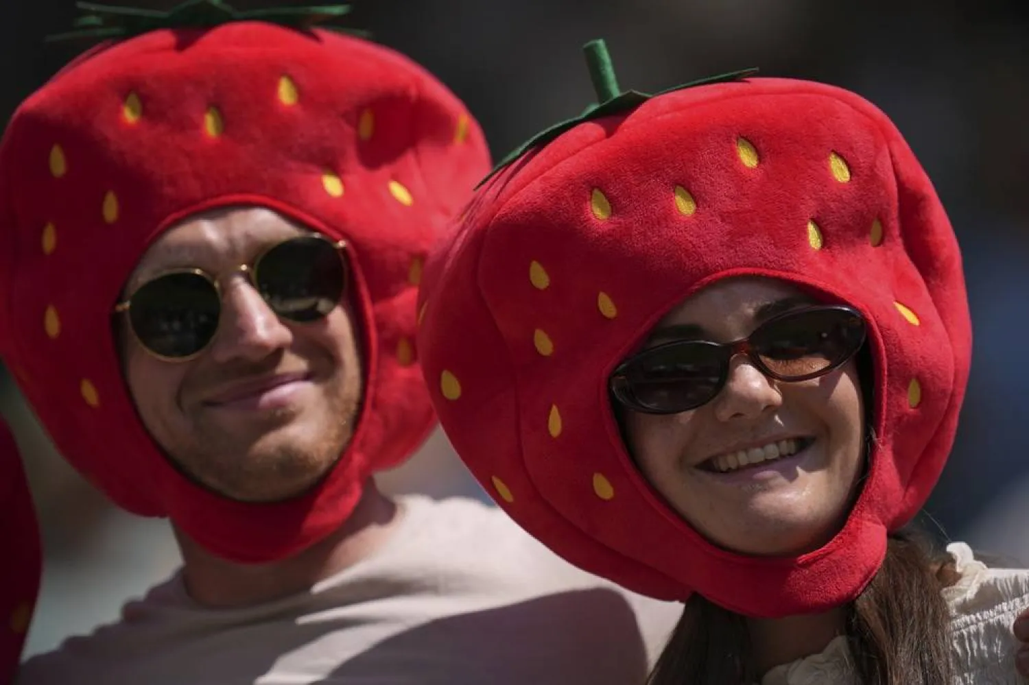  Tennis fans with strawberry hats watch tennis during the Wimbledon Tennis Championships in London, Monday, June 30, 2025. (AP)