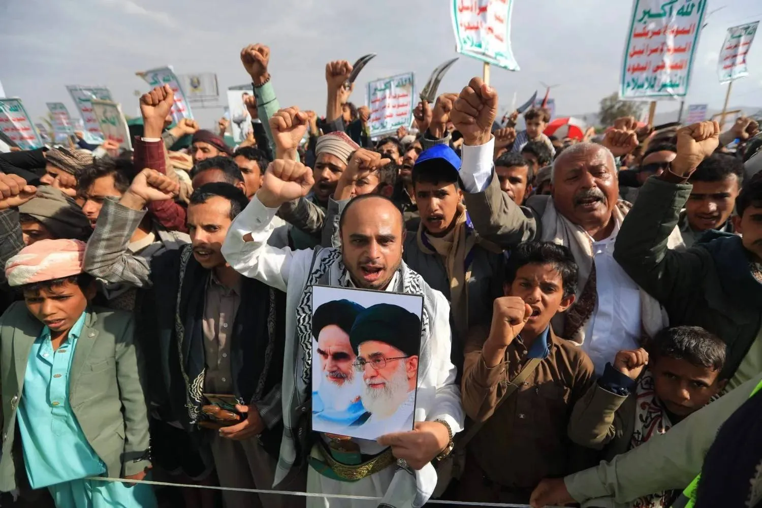 Houthi supporters gathered in Yemen's capital, Sanaa, for a rally in solidarity with Iran, holding up portraits of Iran’s late Supreme Leader and his successor (AFP)