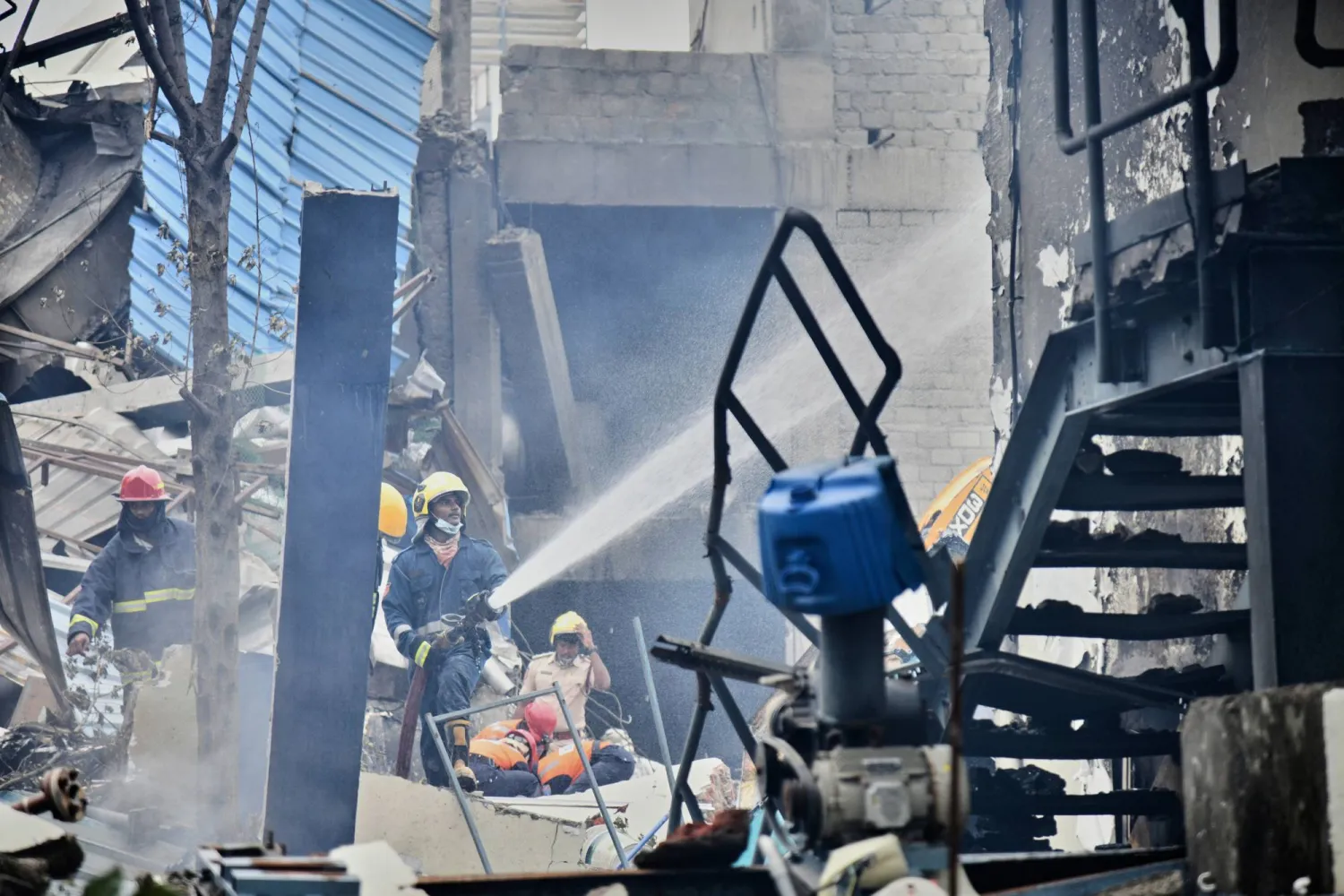 Firefighters extinguish a fire after an explosion at a pharmaceutical factory in an industrial area in Sangareddy some 50 kilometers (31 miles) from Hyderabad, India, Monday, June 30, 2025. (AP Photo)