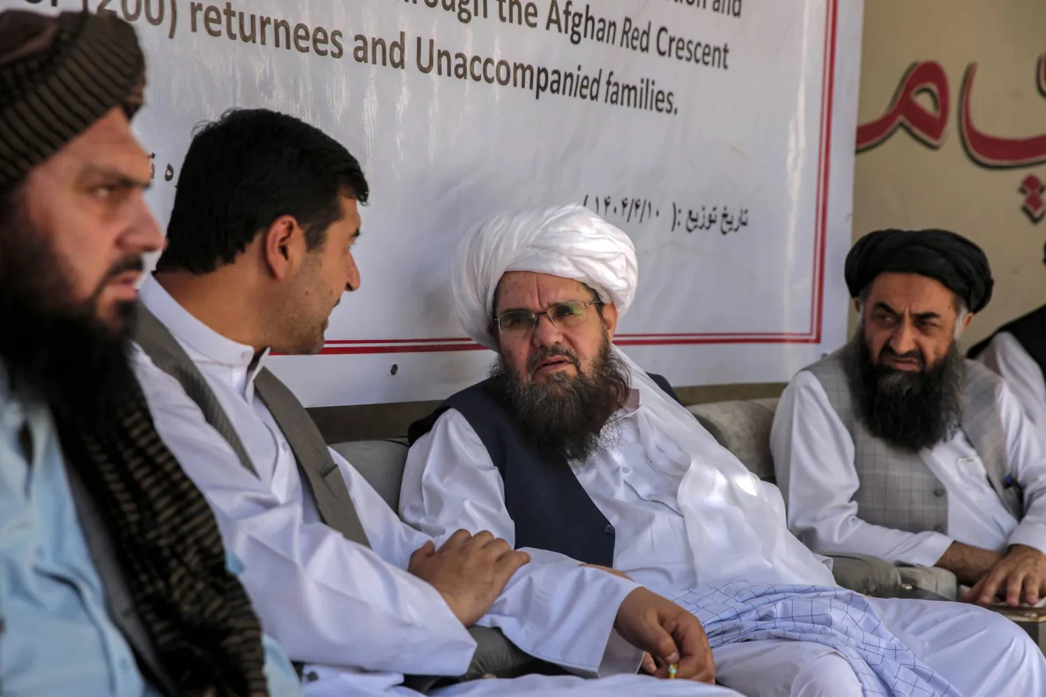 الشيخ الحديث شهاب الدين ديلاوار (الثاني من اليمين) القائم بأعمال المدير العام للهلال الأحمر الأفغاني في حركة «طالبان» حضر حفل توزيع مواد غذائية على اللاجئين الأفغان العائدين من إيران في كابل بأفغانستان - 1 يوليو 2025 (إ.ب.أ )