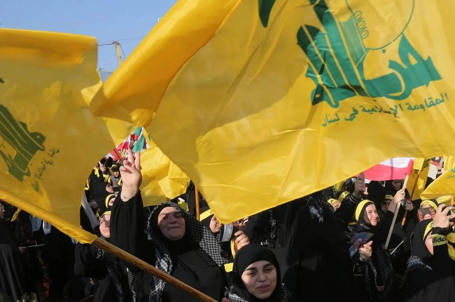 Supporters of Hezbollah carry flags of Hezbollah as they shout slogans during a celebration organized by Hezbollah in front of the Iranian Embassy in Beirut, Lebanon, 25 June 2025. (EPA)
