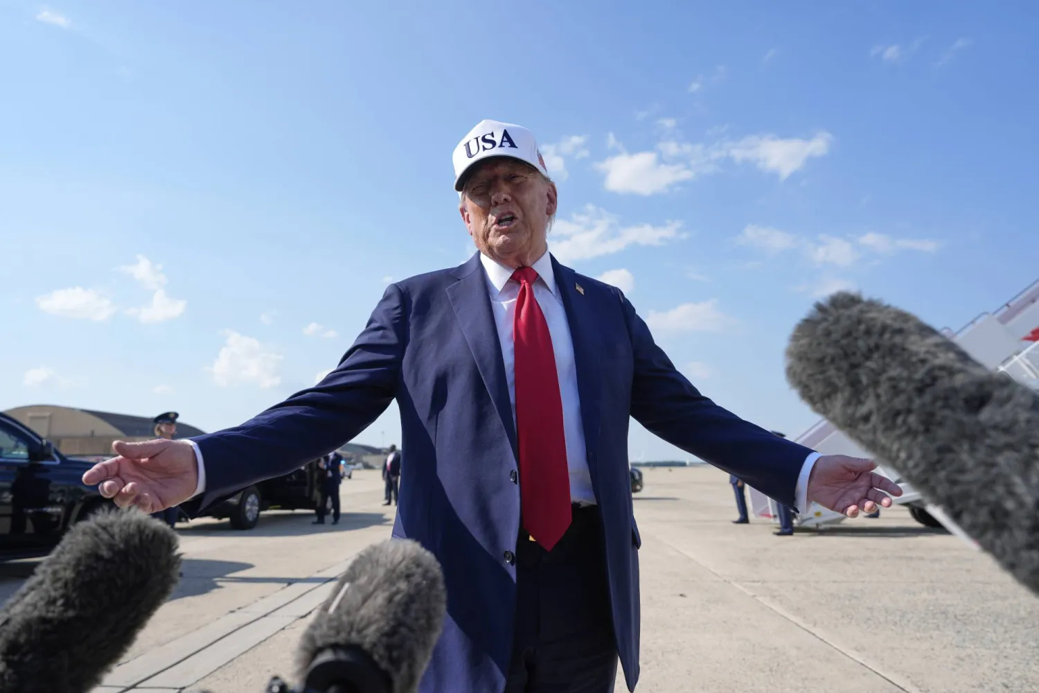 President Donald Trump talks to reporters before boarding Air Force One, Thursday, July 3, 2025, at Joint Base Andrews, Md. (AP Photo/Alex Brandon)