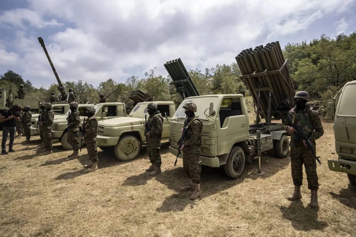 Hezbollah fighters stand before rocket launchers during military drill in Southern Lebanon, May 2023 (AP) 