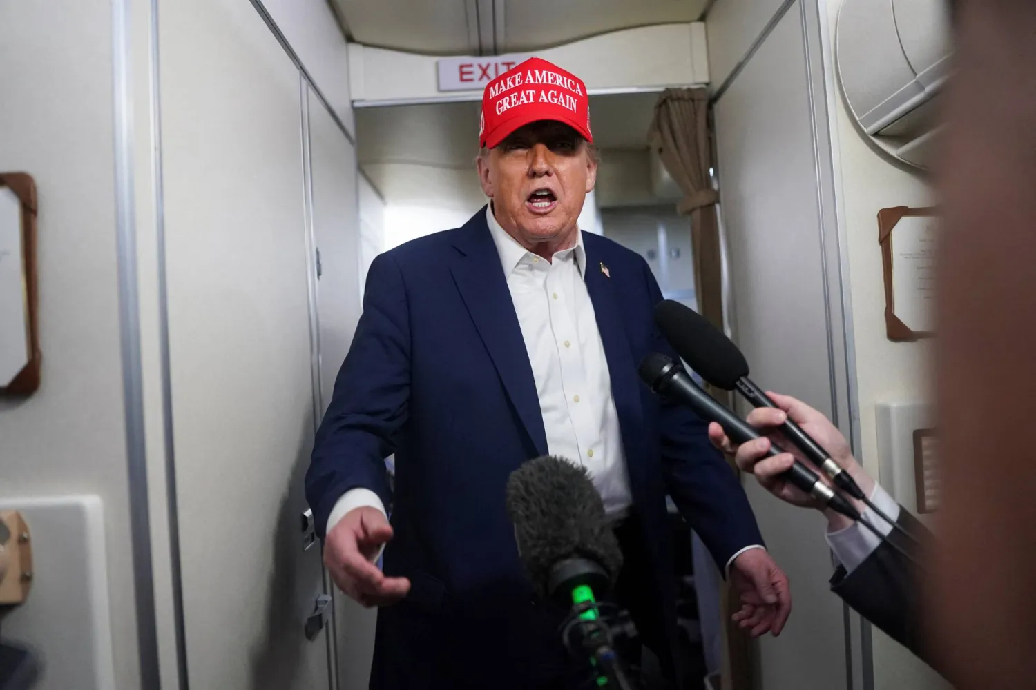 US President Donald Trump speaks to members of the media on board Air Force One on the way to New Jersey, US, July 4, 2025. REUTERS/Nathan Howard