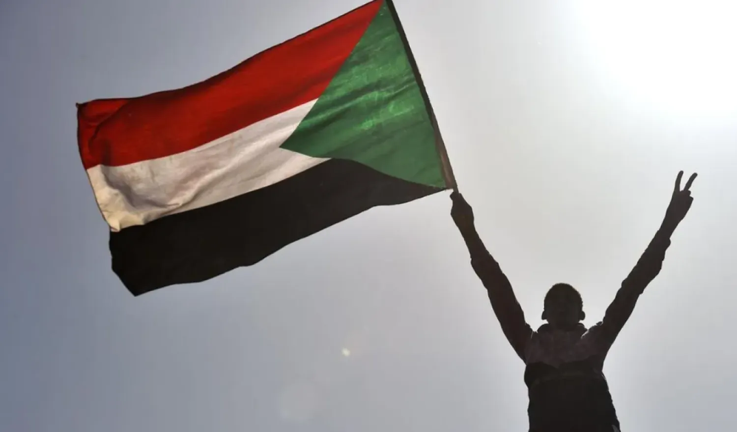 A Sudanese protester waves the national flag near the military headquarters in the capital Khartoum. (AFP)
