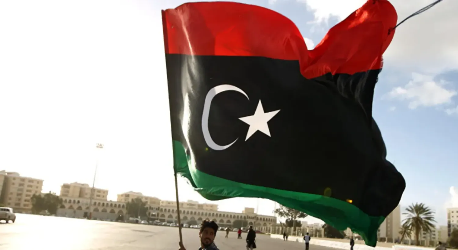Man waving the Libyan flag - File Photo/AFP
