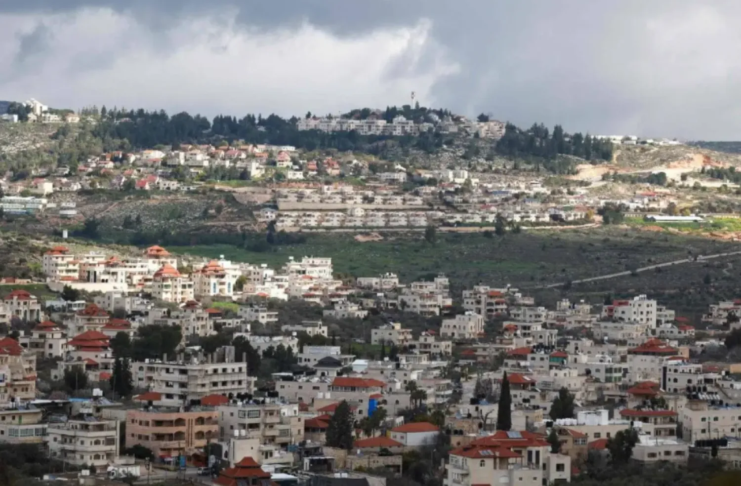 A picture taken in the village of Turmus Ayya near Ramallah city shows the nearby Israeli Shilo settlement in the background, in the occupied West Bank on February 18, 2024. (Photo by Jaafar ASHTIYEH / AFP)
