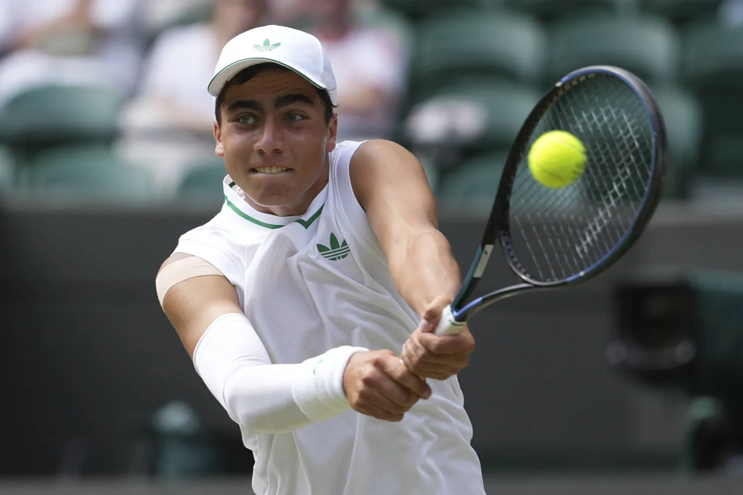 Ivan Ivanov of Bulgaria returns to Ronit Karki of the US in the boys' singles final at the Wimbledon Tennis Championships in London, Sunday, July 13, 2025. (AP Photo/Dave Shopland)