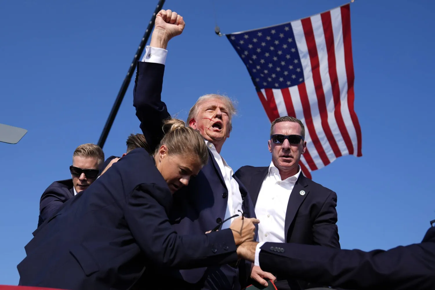 FILE - Republican presidential candidate former President Donald Trump is surrounded by US Secret Service agents at a campaign rally, July 13, 2024, in Butler, Pa. President-elect Donald Trump will choose Sean Curran, right, as Secret Service Director.  (AP Photo/Evan Vucci, File)