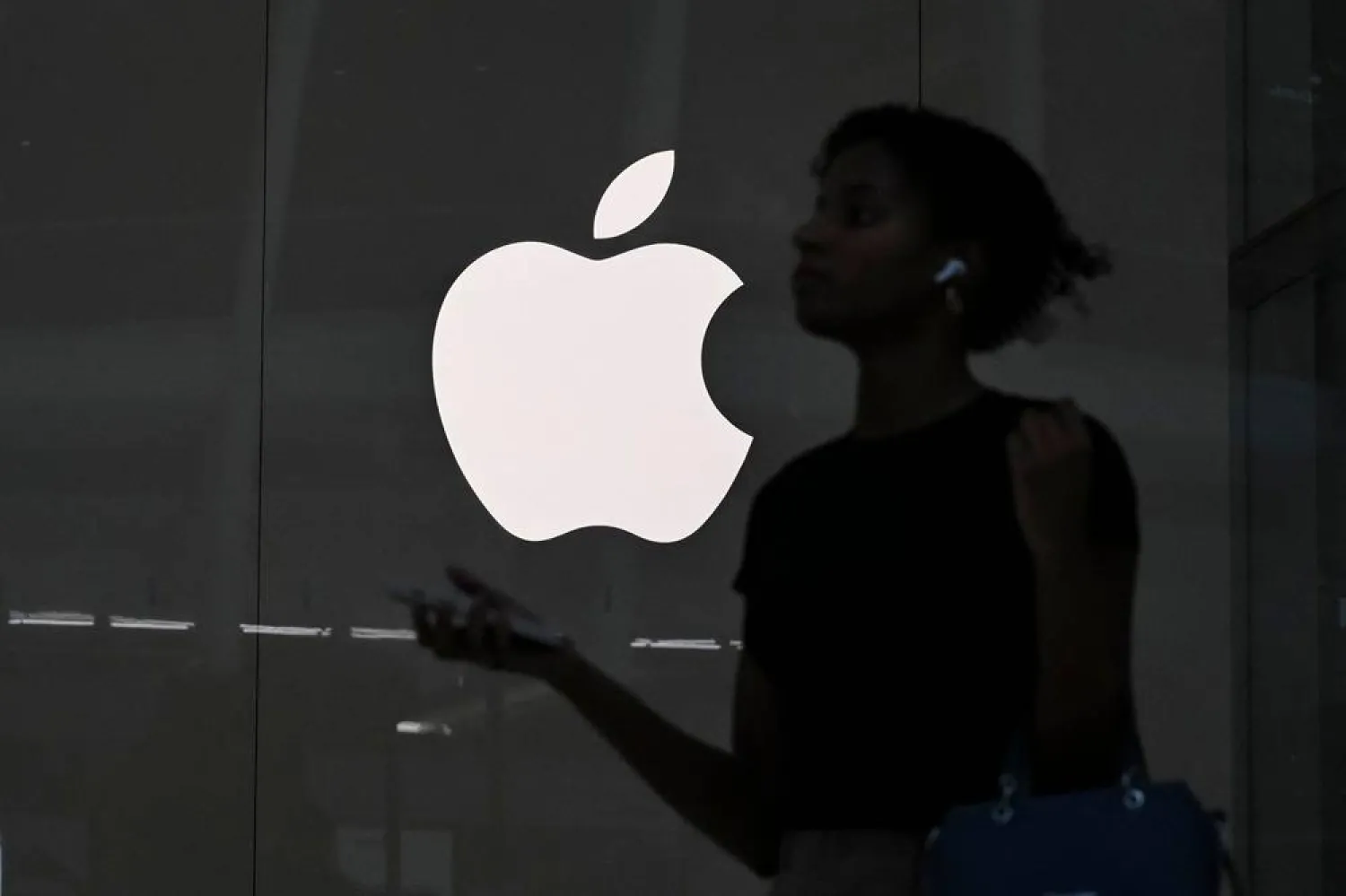 A person walks past an Apple store on July 15, 2025, in New York City. (AFP)