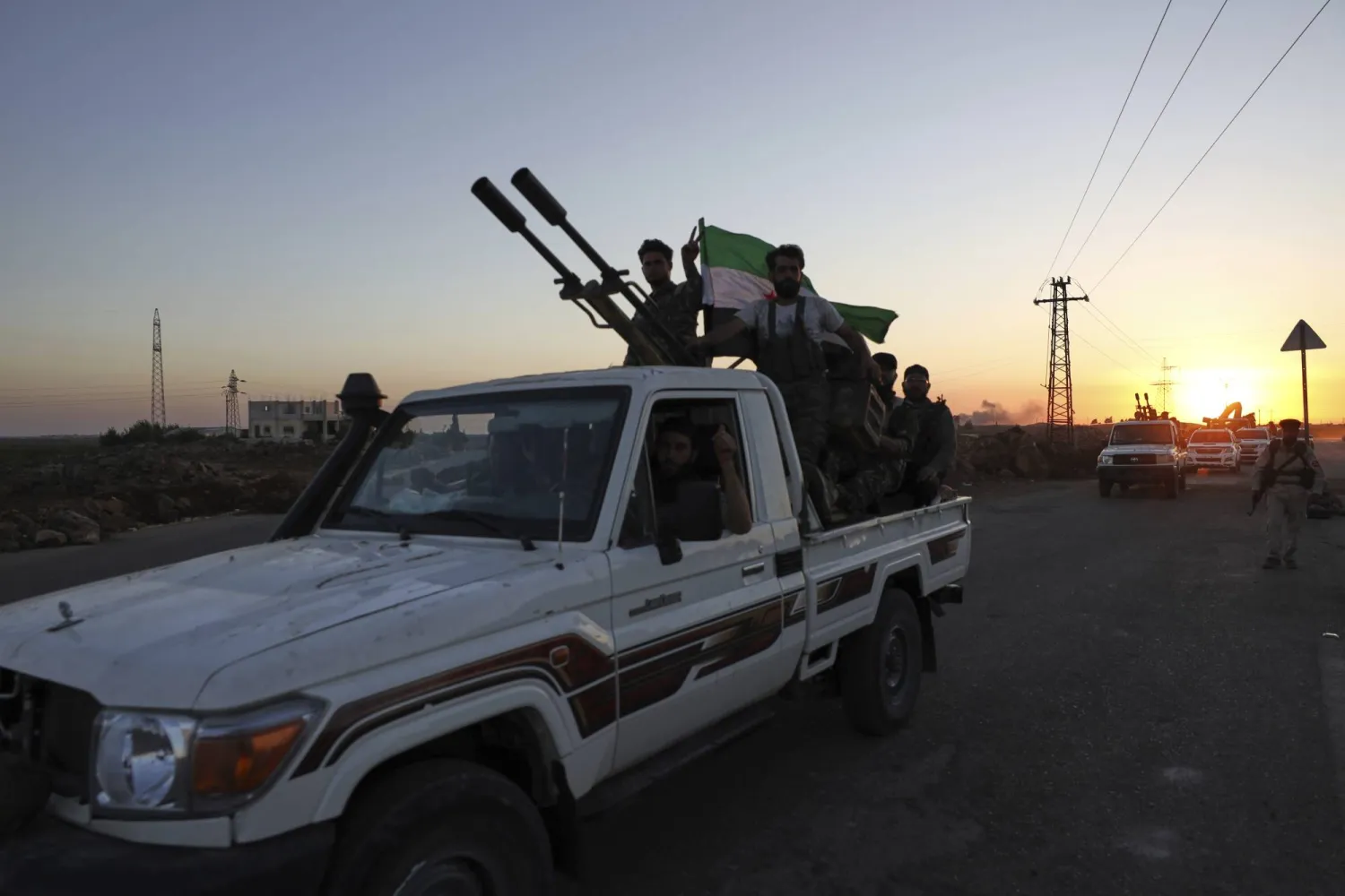 A convoy of government forces drives toward Sweida city as it passes through Mazraa village in southern Syria, Tuesday, July 15, 2025. (AP Photo/Omar Albam)