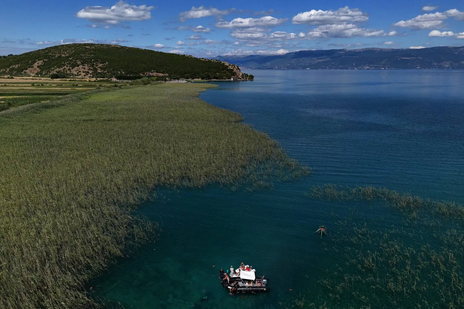 A drone view shows archaeologists diving in the lake of Ohrid to uncover objects, in the village of Lin, Albania, July 10, 2025. REUTERS/Fatos Bytyci