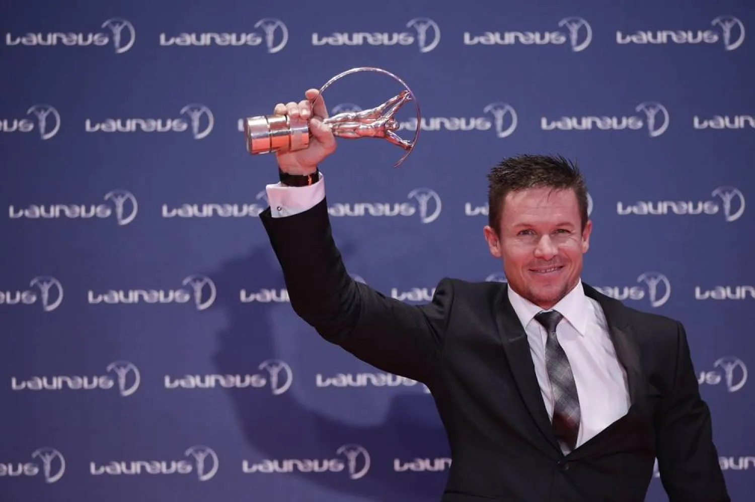 Austria skydiver Felix Baumgartner holds the Laureus World Action Sportsperson trophy as he poses for pictures during the Year at the Laureus World Sports Awards in Rio de Janeiro, Brazil, March 11, 2013. (AP)