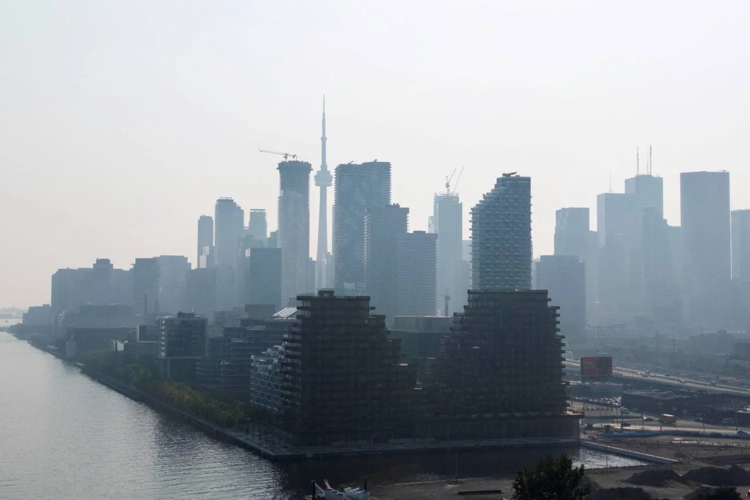 A hazy view of the skyline in Toronto, Ontario, Canada, July 14, 2025. REUTERS/Carlos Osorio.