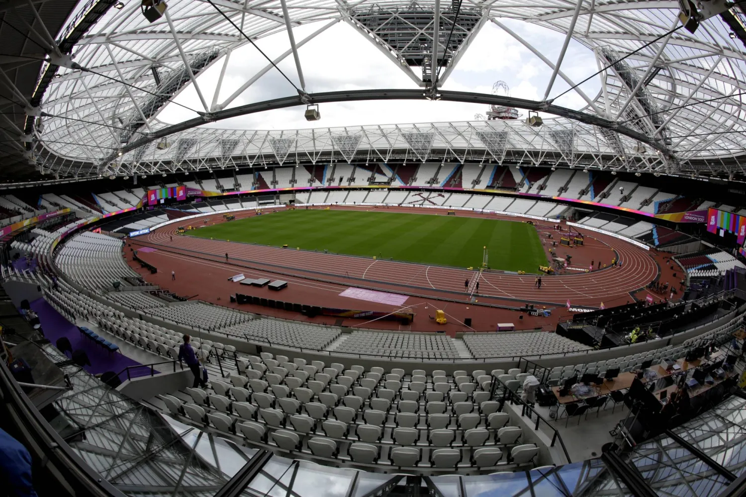 FILE -Workers continue setup preparations ahead of the start of the World Athletics Championships at the London Stadium, in the Queen Elizabeth Olympic Park in London, Aug. 1, 2017. (AP Photo/Matt Dunham, File)