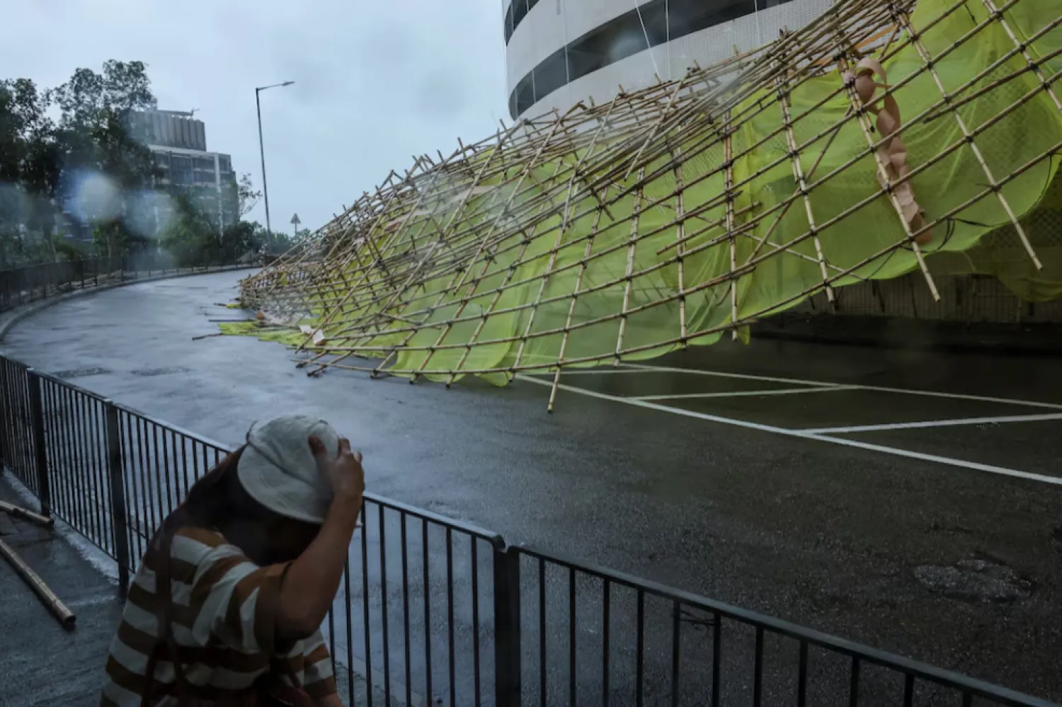Collapsed bamboo scaffolds of a residential building are seen as Typhoon Wipha approaches, in Hong Kong, China, July 20, 2025. REUTERS/Tyrone Siu 