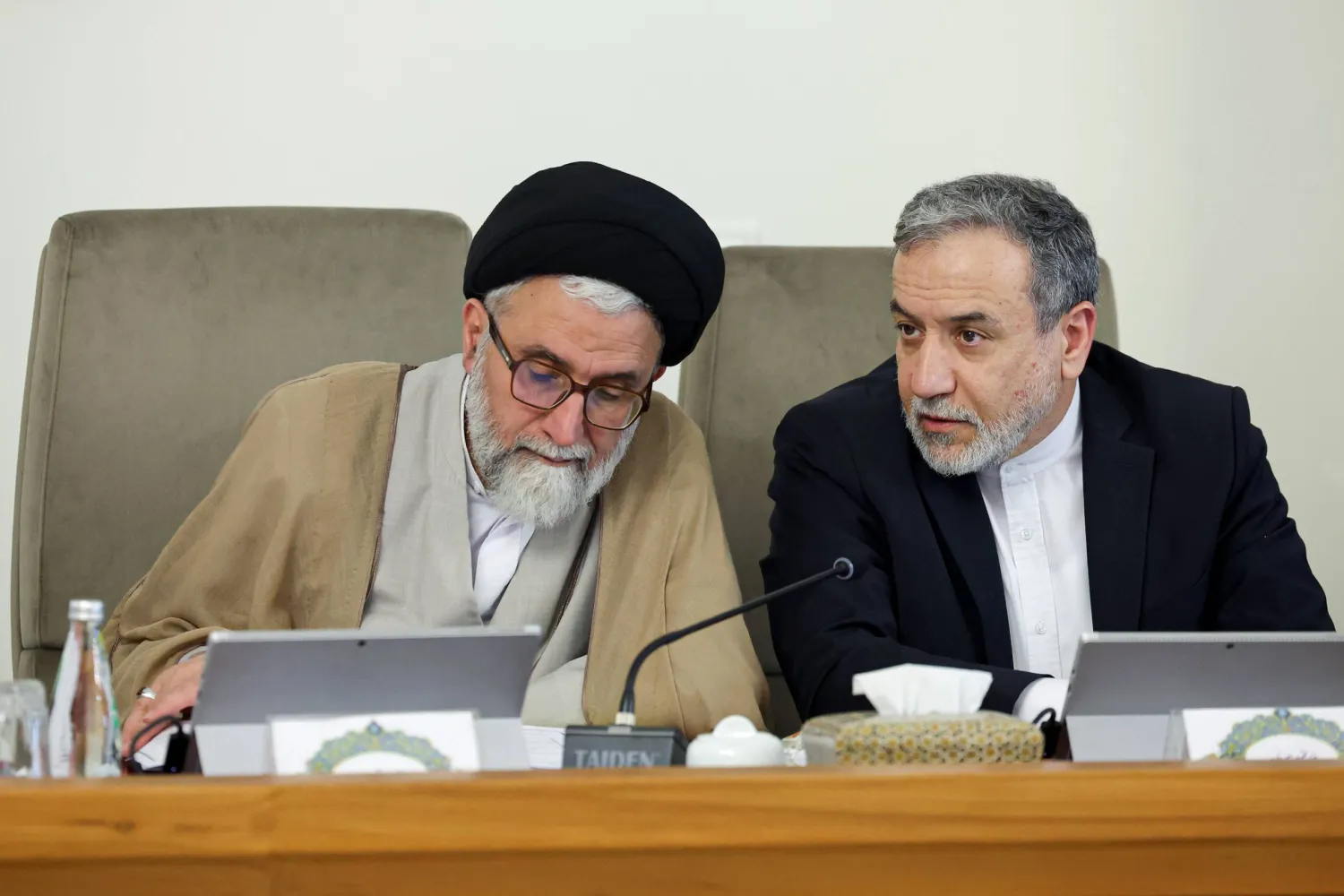 وزير الخارجية عباس عراقجي يهمس في أذن وزير الاستخبارات إسماعيل خطيب على هامش اجتماع الحكومة - 9 يوليو الماضي (الرئاسة الإيرانية)