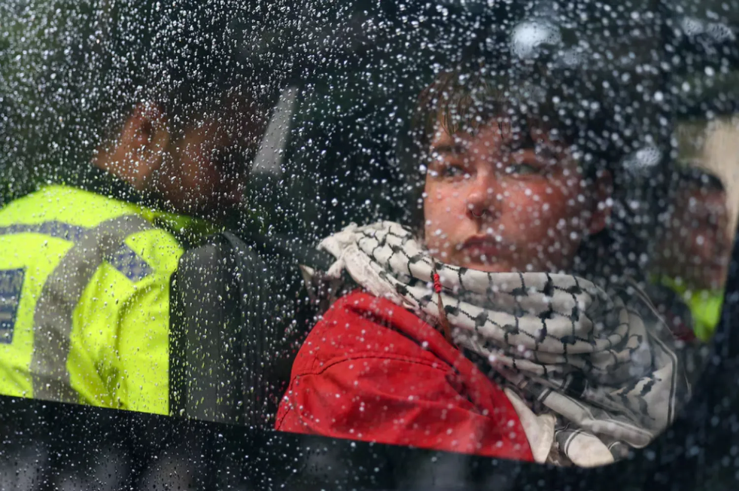 A detained demonstrator sits inside a police van, following a protest in support of the Palestine Action group in Parliament Square in London, Britain, July 19, 2025. REUTERS/Isabel Infantes 