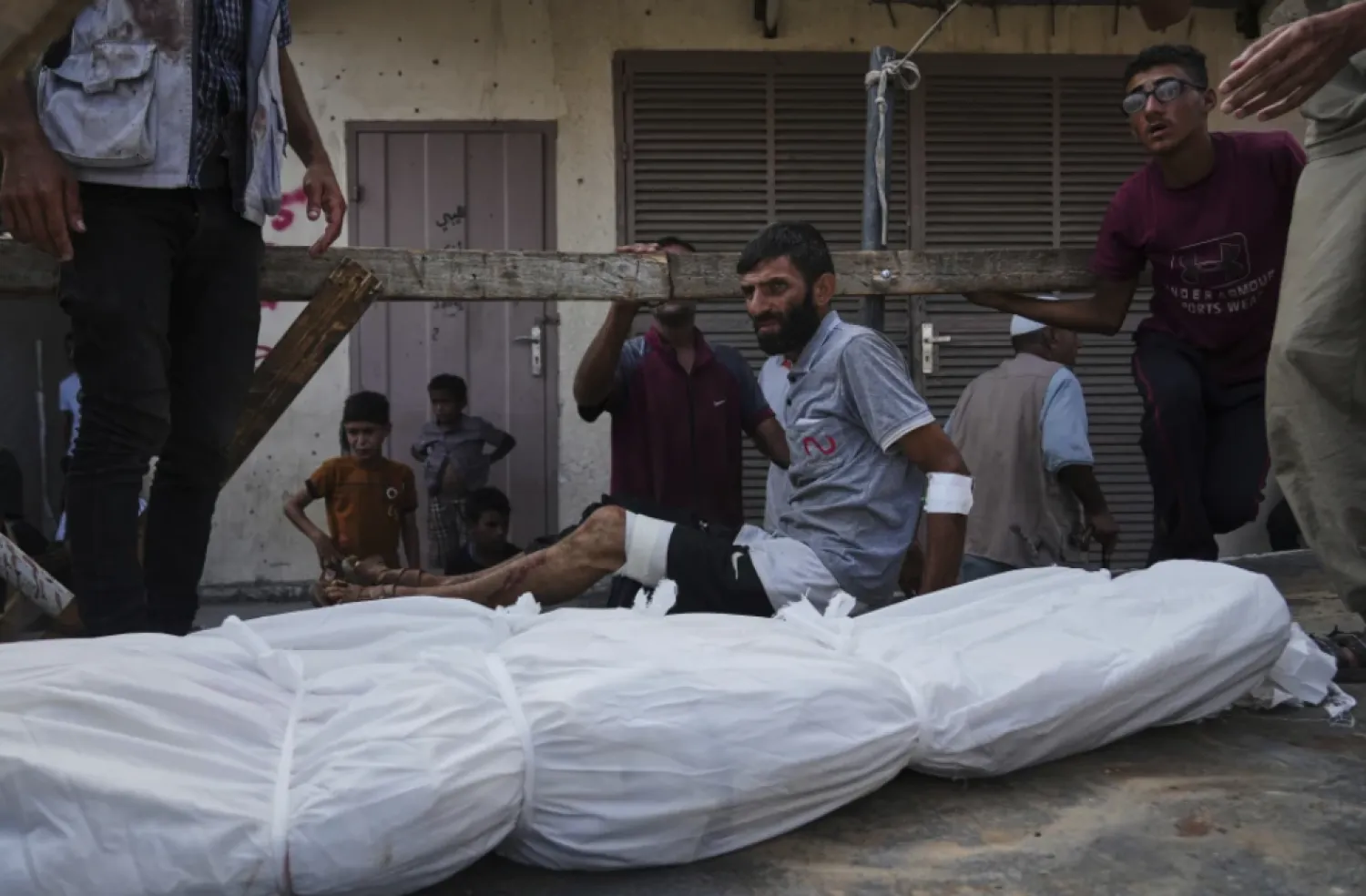 Mourners attend the funeral of their relatives killed in an Israeli bombardment, in Deir al-Balah, central Gaza Strip, Monday, July 21, 2025. (AP Photo/Abdel Kareem Hana)

