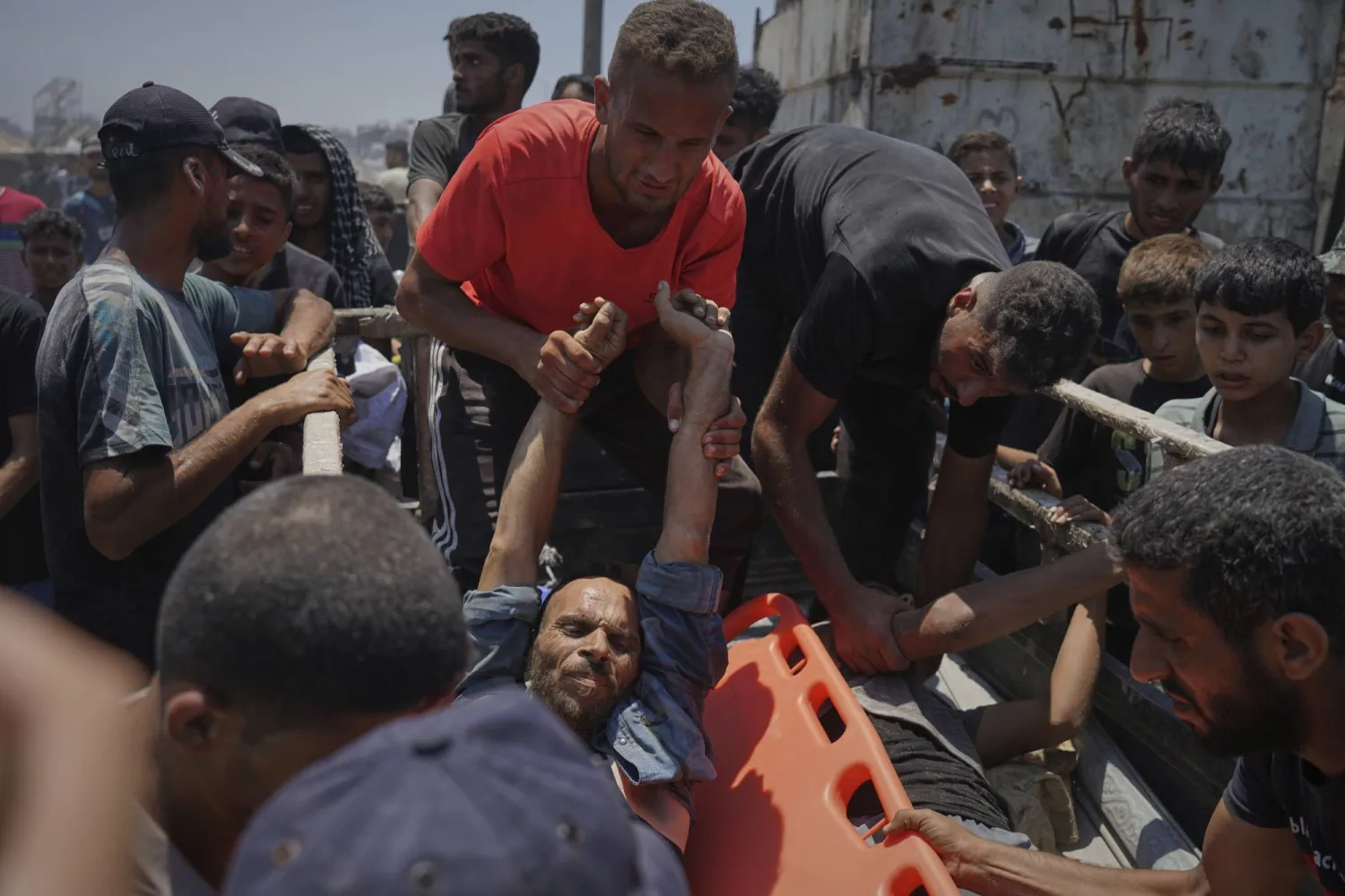 فلسطينيون ينقلون جرحى أصيبوا خلال انتظارهم للحصول على مساعدة غذائية بمدينة غزة الثلاثاء (أ.ب)