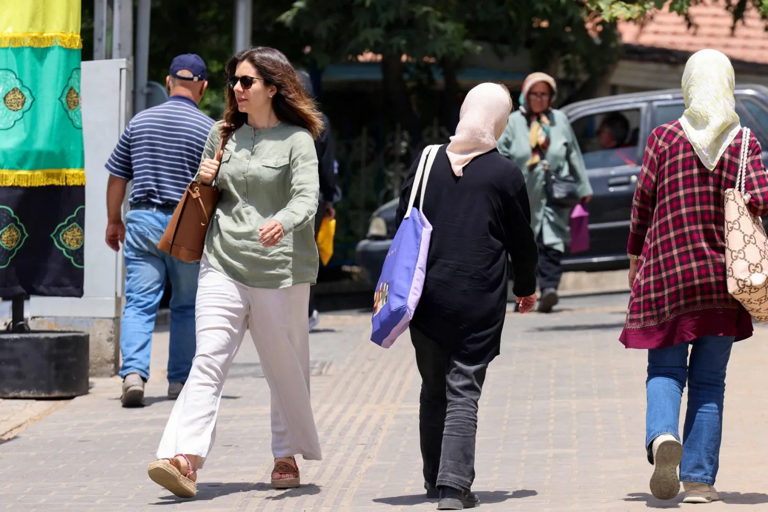 عابرون في ساحة تجريش شمال العاصمة الإيرانية 30 يونيو (أ.ف.ب)