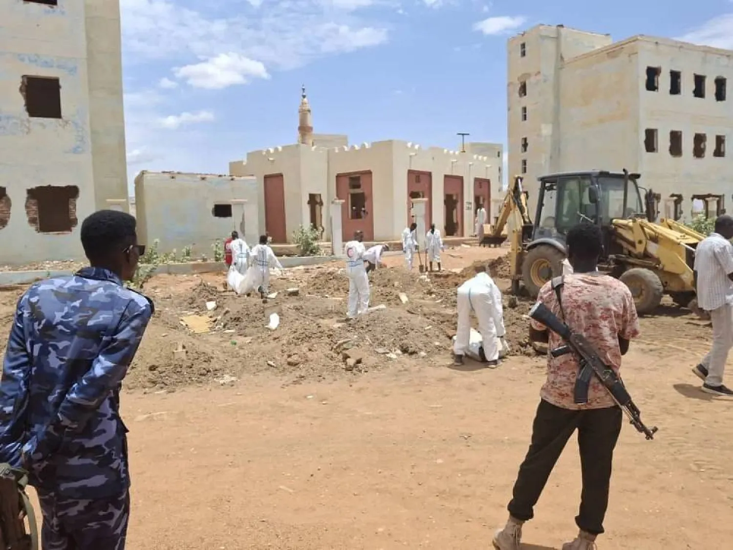 A Red Crescent team exhumes bodies from a mass grave in Khartoum. (Asharq Al-Awsat) 