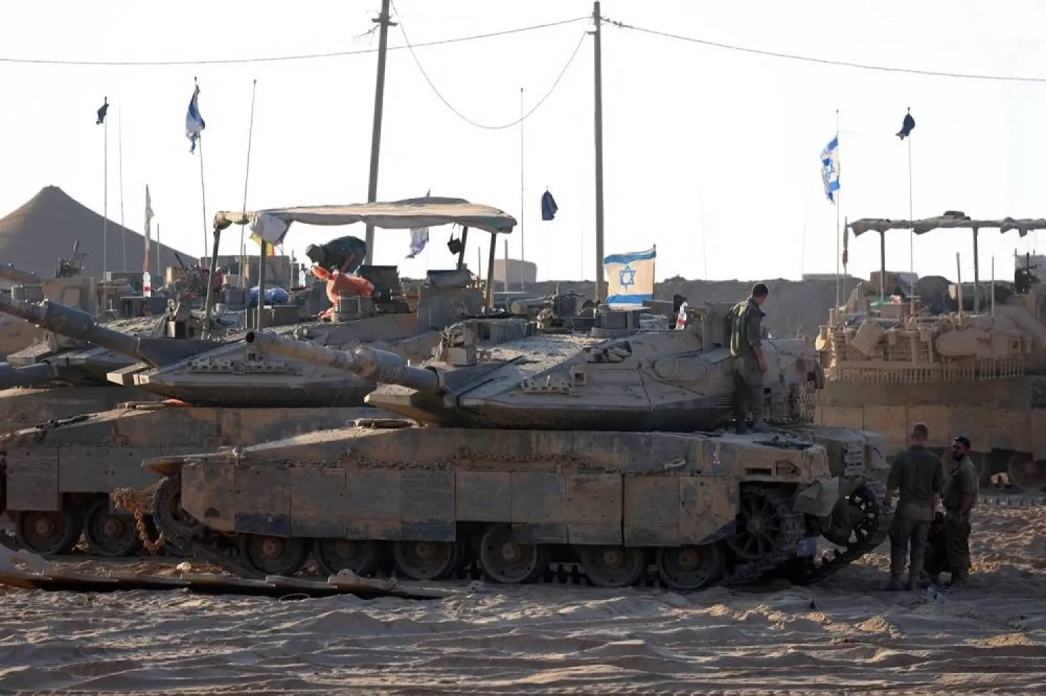 Israeli tanks are seen near the border of the Gaza Strip on Monday. (AFP) 
