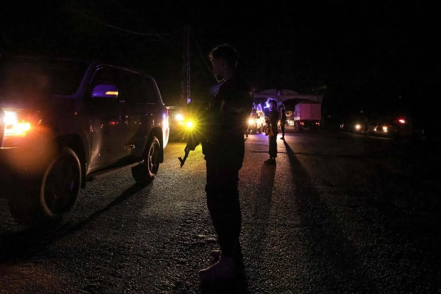 Syrian security forces stand by as a United Nations convoy evacuating families from Sweida moves through the buffer zone in Busra al-Harir in Syria's southern Daraa province on July 22, 2025. (AFP)