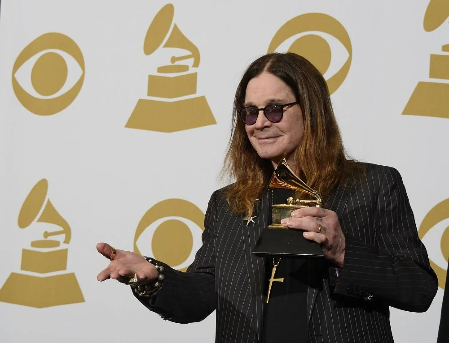 British singer Ozzy Osbourne of Black Sabbath holds up the award for "Best Metal Performance" at the 56th annual Grammy Awards held at the Staples Center in Los Angeles, California, USA, 26 January 2014 (reissued 22 July 2025). (EPA) 