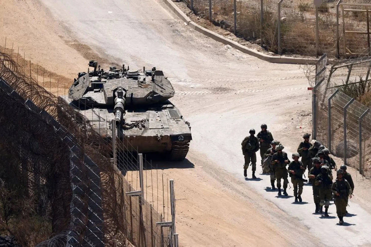 Israeli troops patrol the border fence with Syria near the Druze village of Majdal Shams in the Israel-occupied Golan Heights on July 23, 2025. (AFP)