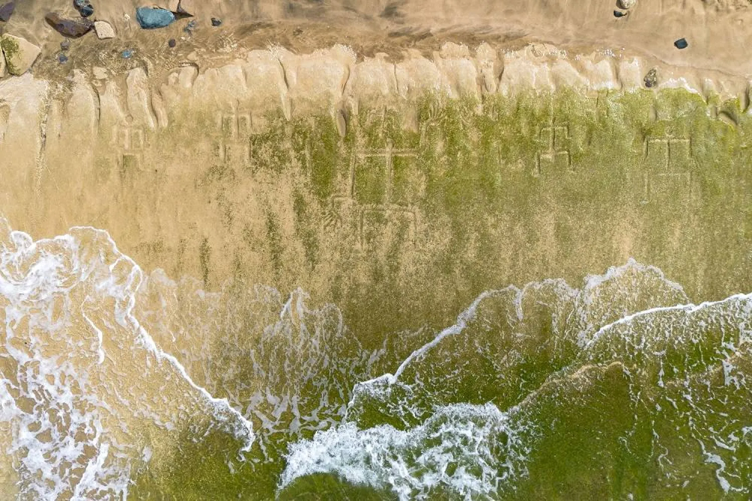 A drone view shows petroglyphs carved into the rock surface at Pokai Bay, July 22, 2025, in Waianae, Hawaii. (AP)