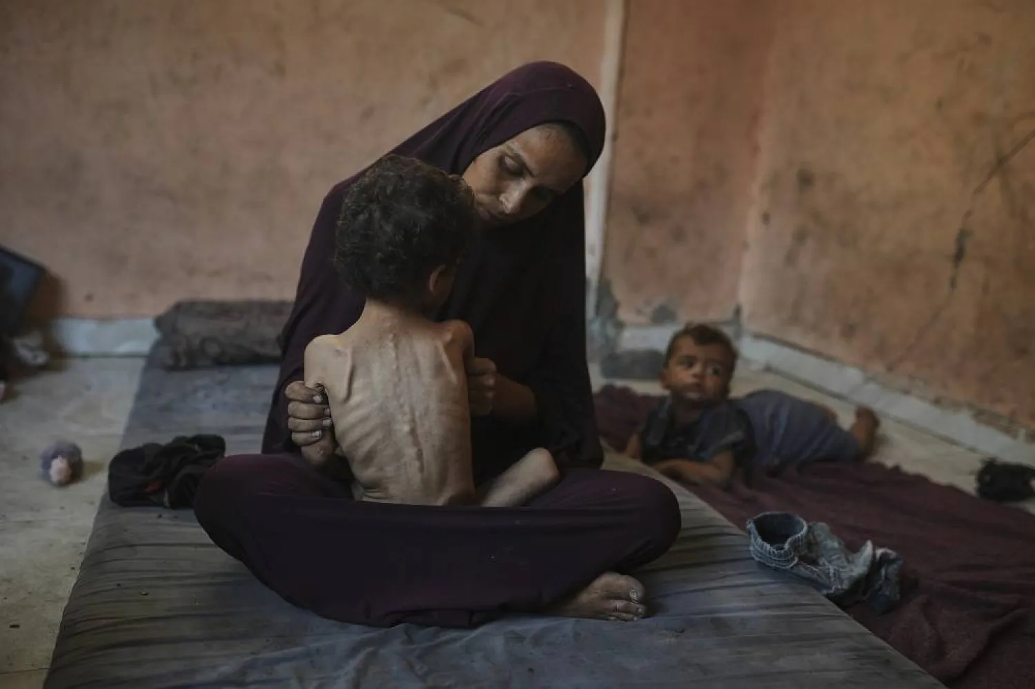 Naima Abu Ful holds her malnourished 2-year-old child, Yazan, at their home in the Shati refugee camp in Gaza City on Wednesday, July 23, 2025. (AP)