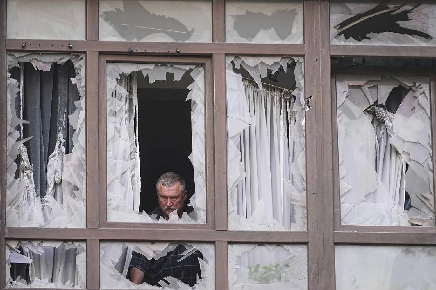 A man stands at the broken windows of his house after a Russian attack in Kyiv, Ukraine, Monday, July 21, 2025. (AP)