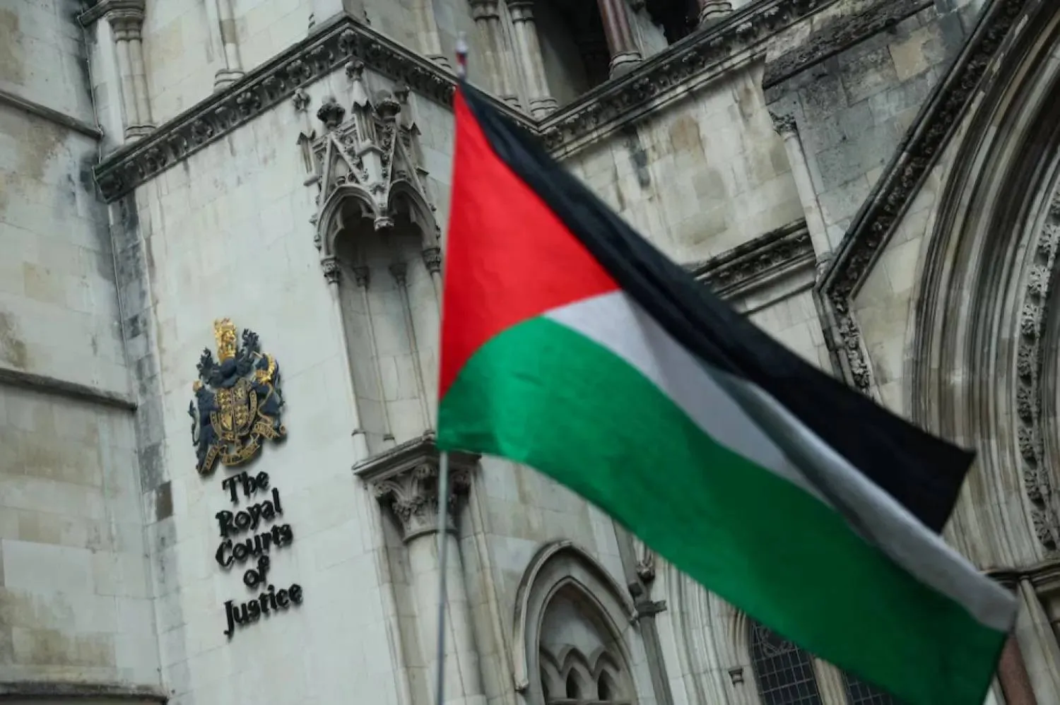 File photo: A person holds a Palestinian flag outside the High Court on the day of a hearing about the banned pro-Palestinian campaign organization Palestine Action, in London, Britain, July 21, 2025. REUTERS
