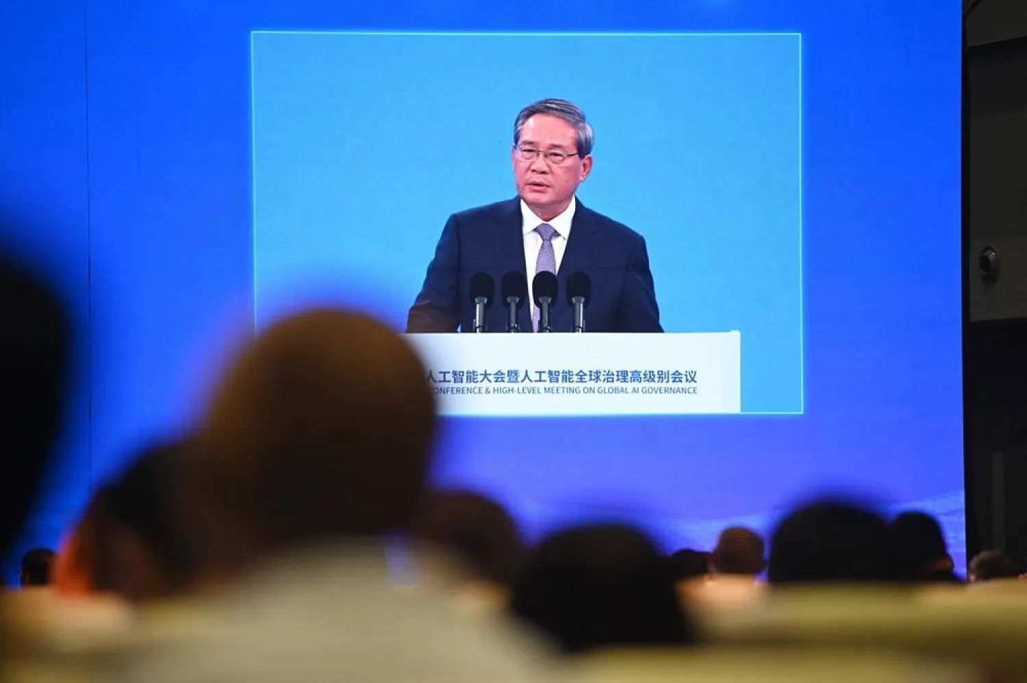 Chinese Premier Li Qiang is seen on a screen as he speaks at the opening ceremony of the World Artificial Intelligence Conference in Shanghai on July 26, 2025. (AFP)