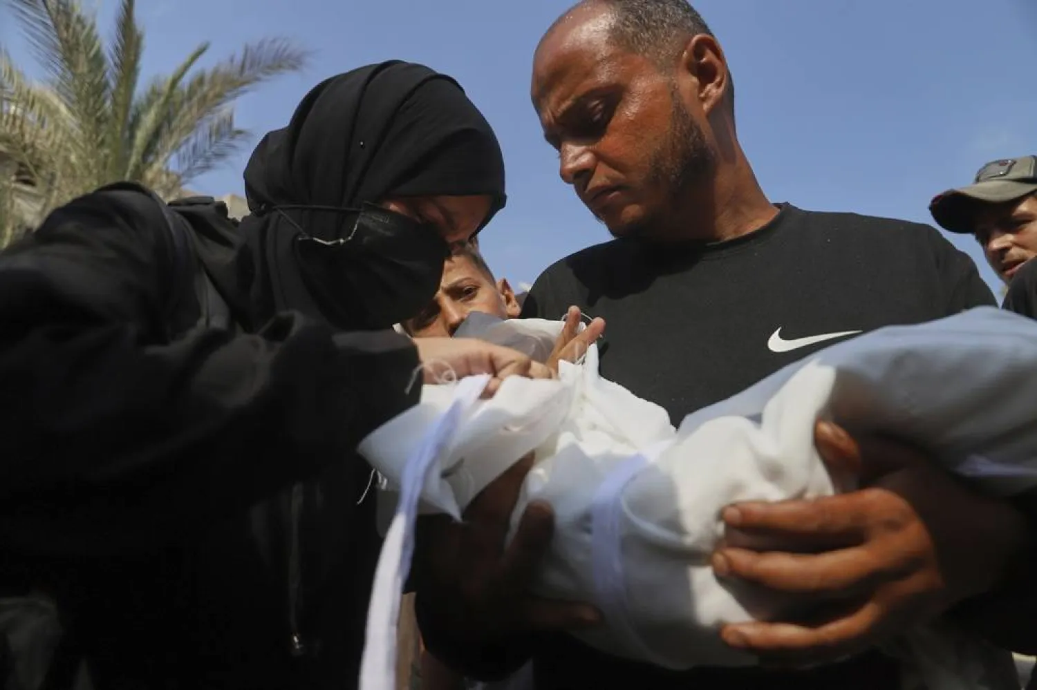 Ahmed Abu Halib and his wife Esraa Abu Halib, left, mourn over the body of their 5-month-old baby, Zainab, who died from malnutrition-related causes, according to the family and the hospital, during her funeral outside the Nasser Hospital, in Khan Younis, Gaza Strip, Saturday, July 26, 2025. (AP) 