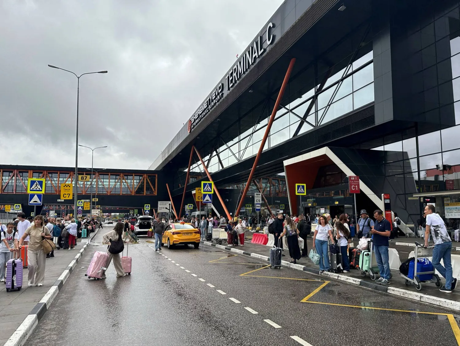 FILE PHOTO: People wait outside Terminal C after many flights were cancelled or delayed due to Ukrainian drone attacks, at Sheremetyevo international airport outside Moscow, Russia July 21, 2025. REUTERS/Stringer/File Photo