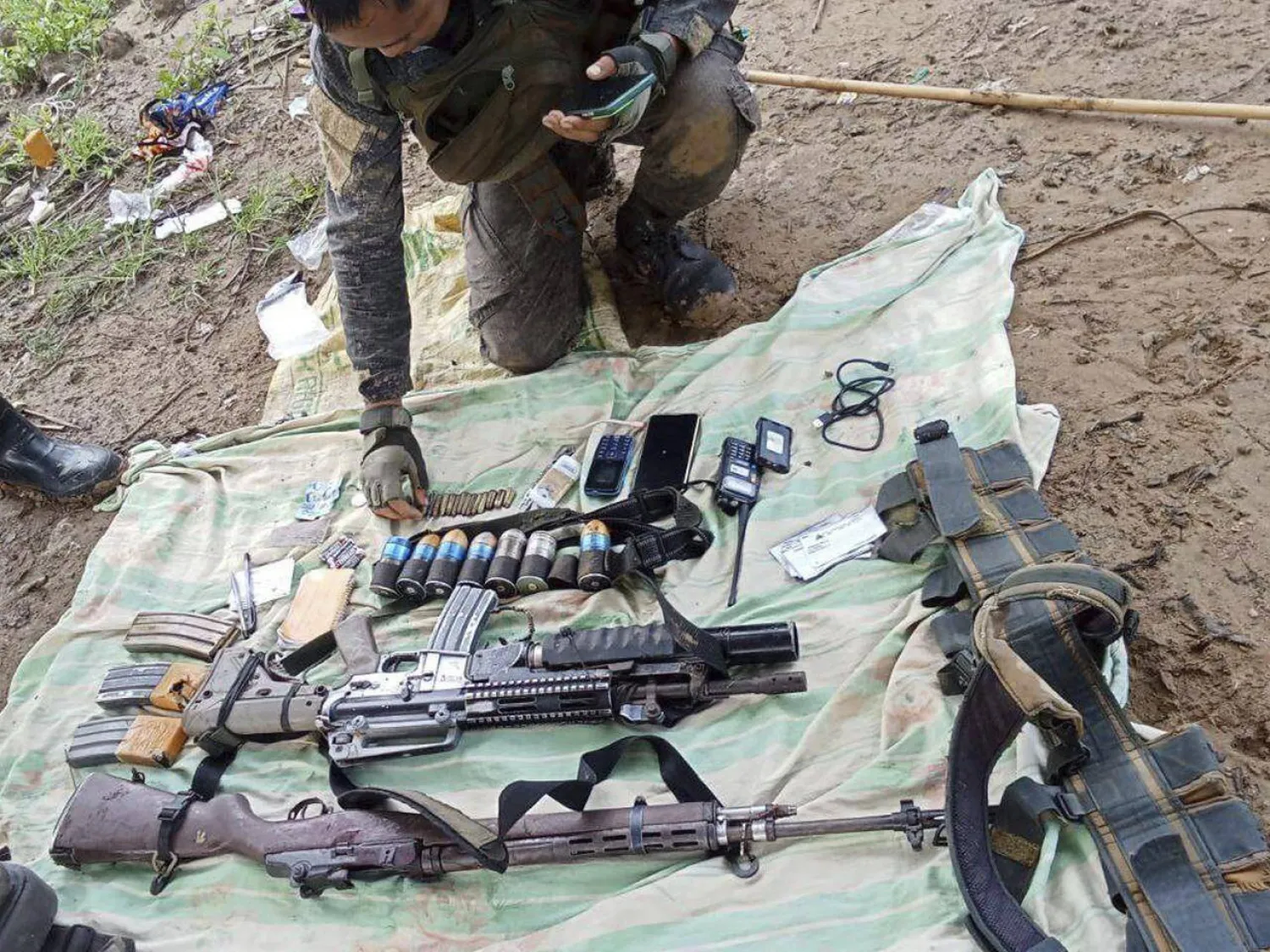 This photo provided by Philippine Army 2nd Infantry Battalion shows assault rifles and grenade launchers recovered by troops after a brief gun battle with communist guerrillas in Masbate province, Philippines Sunday, July 27, 2025.(Philippine Army 2nd Infantry Battalion via AP)