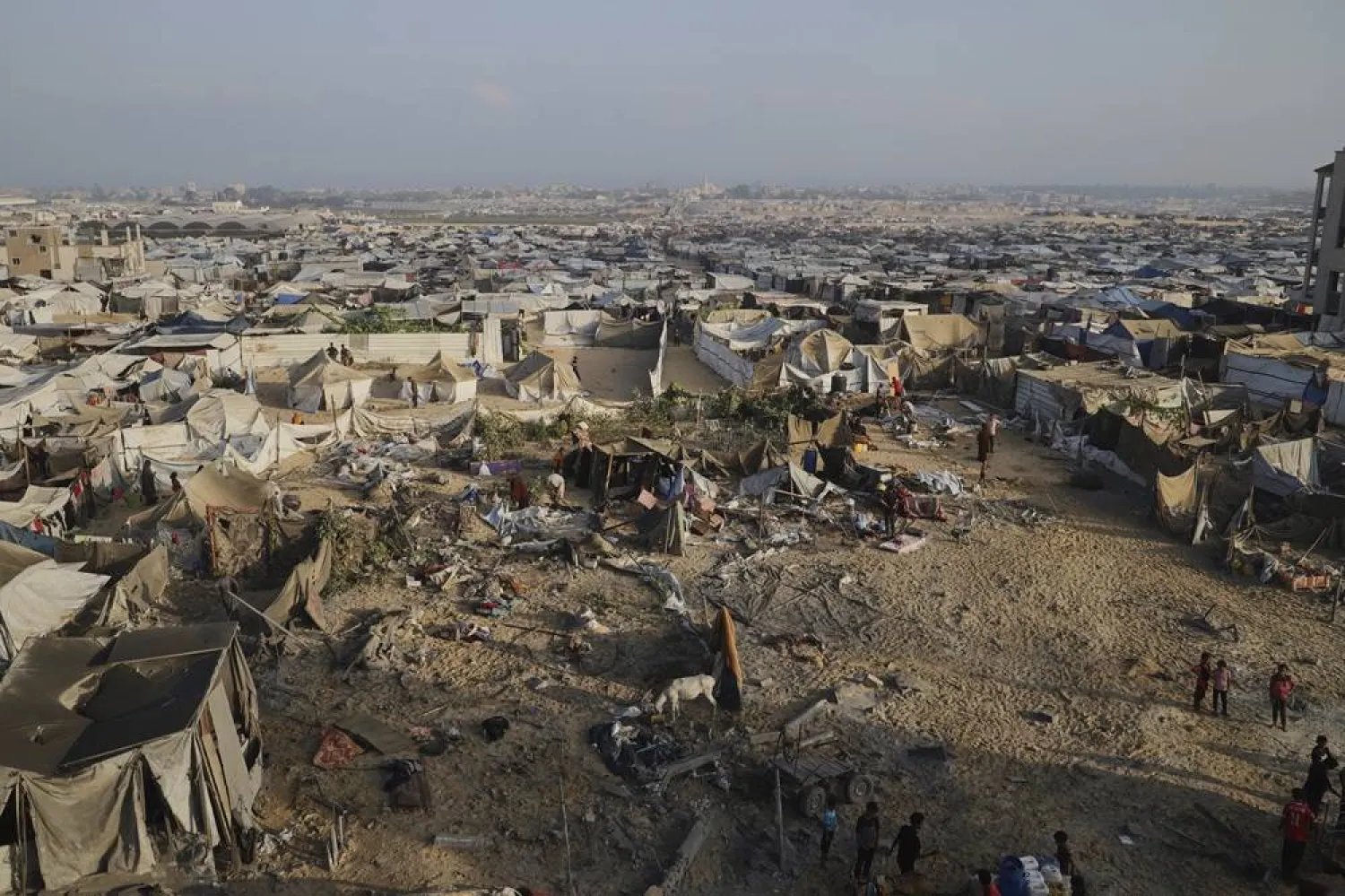 Palestinians inspect the site struck by an Israeli bombardment in Muwasi, Khan Younis, Gaza Strip, Monday, July 28, 2025. (AP)