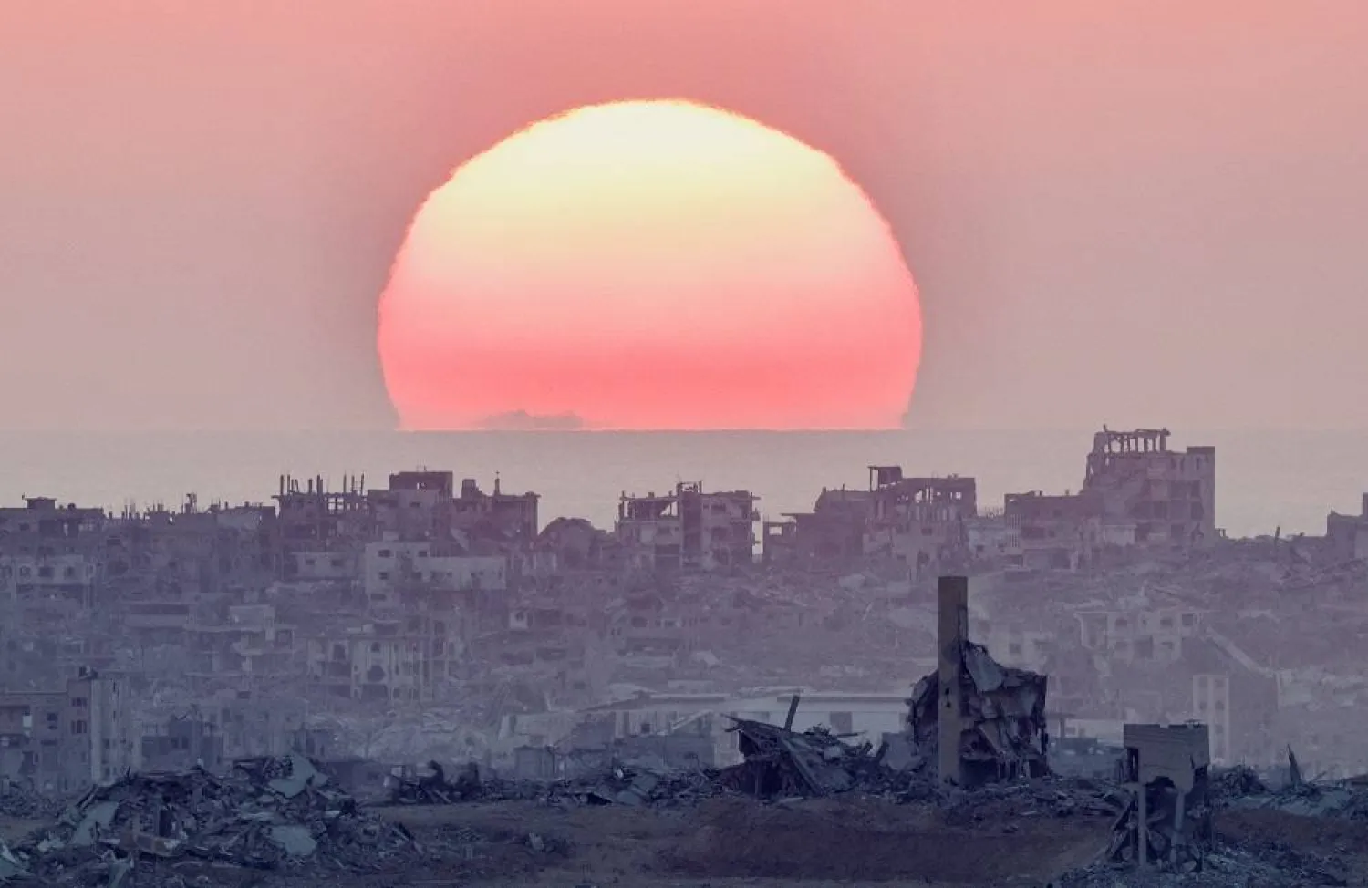 The sun sets over north Gaza, as seen from the Israeli side of the border, July 28, 2025. (Reuters)