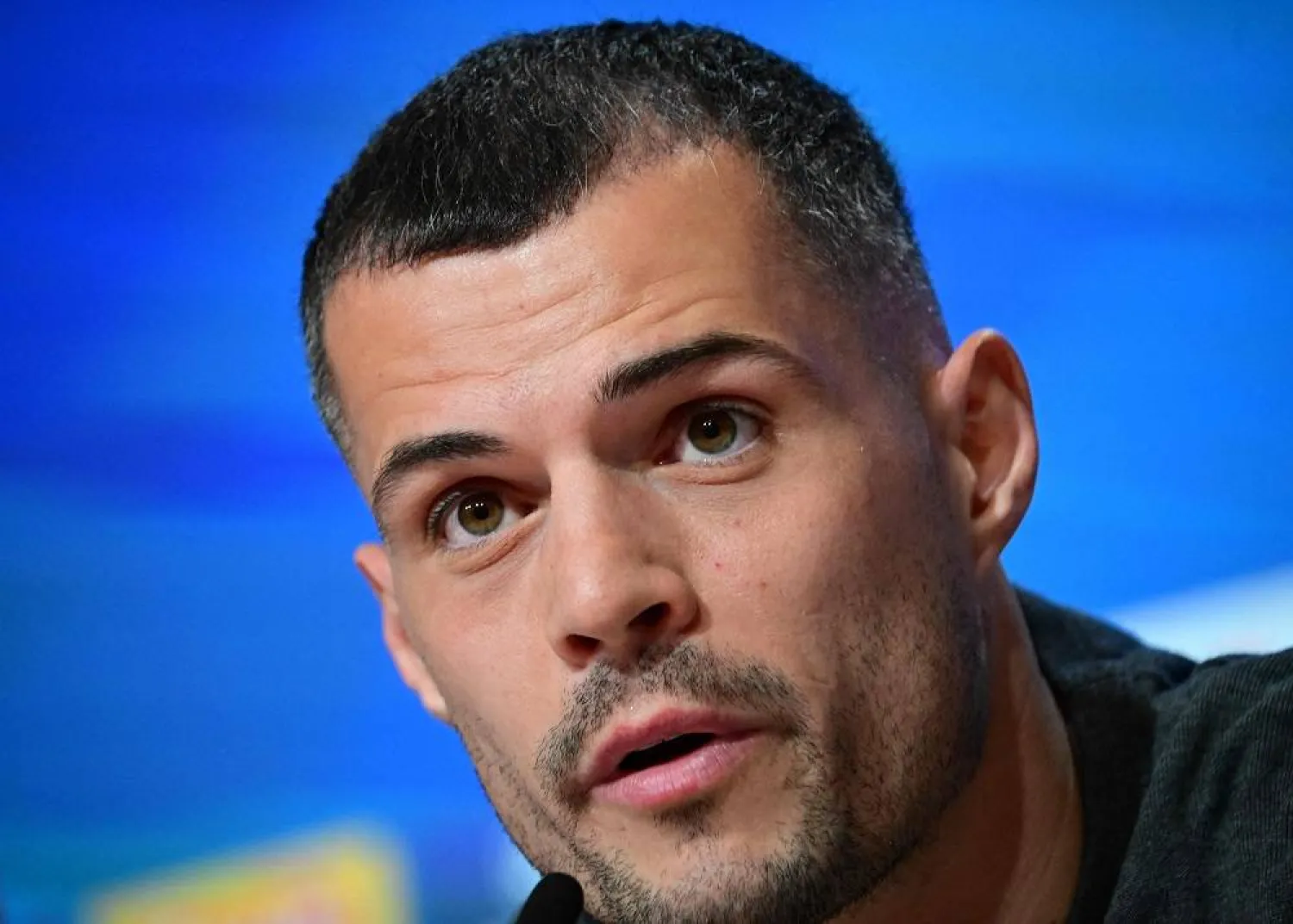 Bayer Leverkusen's Swiss midfielder #34 Granit Xhaka speaks during a press conference on the eve of the UEFA Champions League Last 16, first-leg, football match FC Bayern Munich v Bayer 04 Leverkusen on March 4, 2025 in Munich, southern Germany. (AFP)