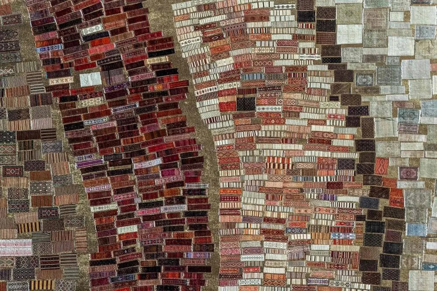 An aerial view shows handwoven carpets laid out in the open fields to soften their colors under sizzling sun in Dosemealti district in Antalya on July 22, 2025. (AFP)