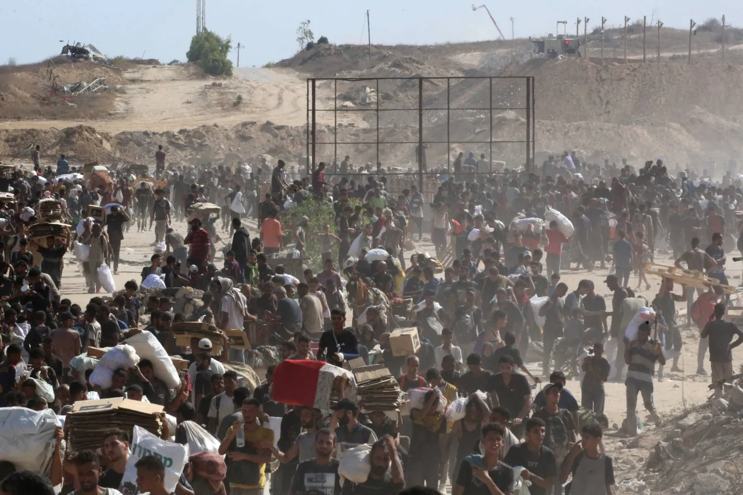 نازحون فلسطينيون يتجمّعون لتلقي المساعدات من نقطة توزيع مساعدات في «ممر نتساريم» وسط قطاع غزة 30 يوليو 2025 (أ.ف.ب)